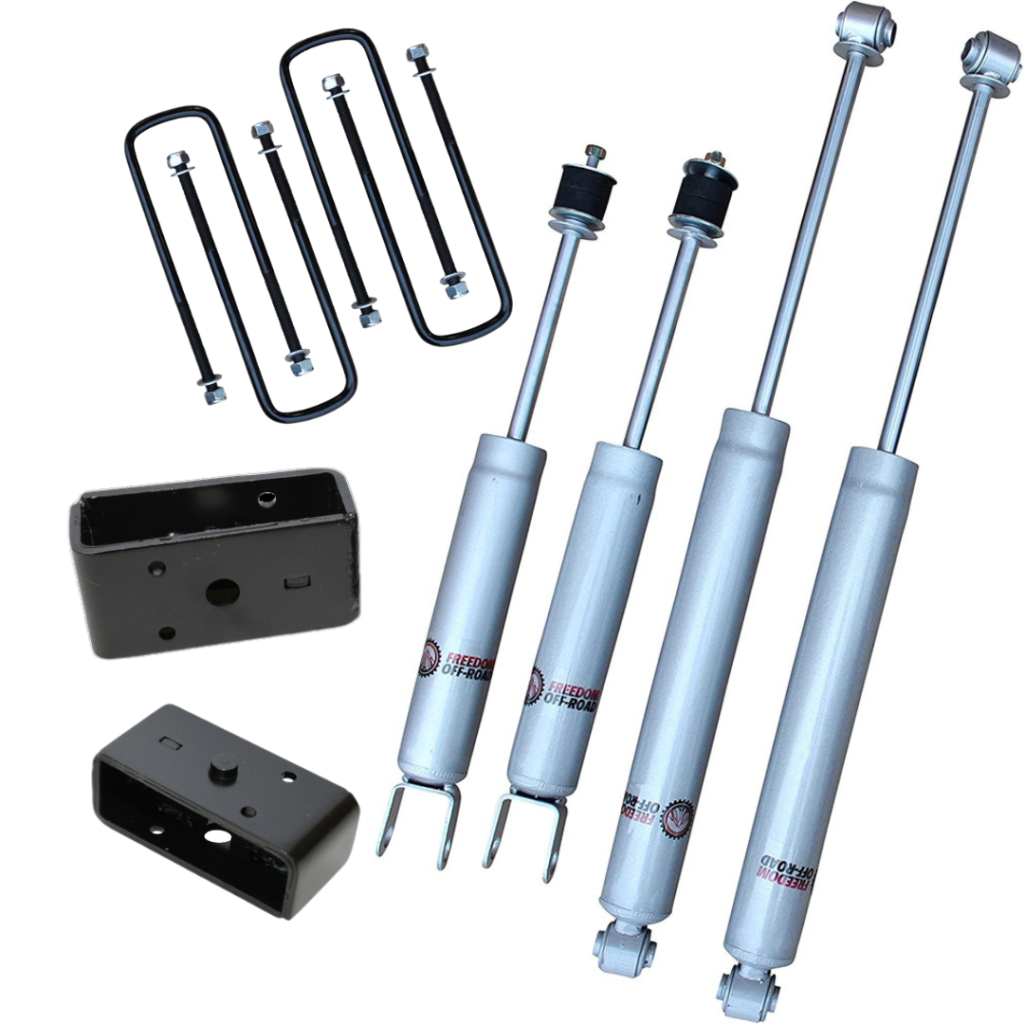 Freedom Off-Road shocks and lift blocks with U-bolts laid out for vehicle suspension upgrade.