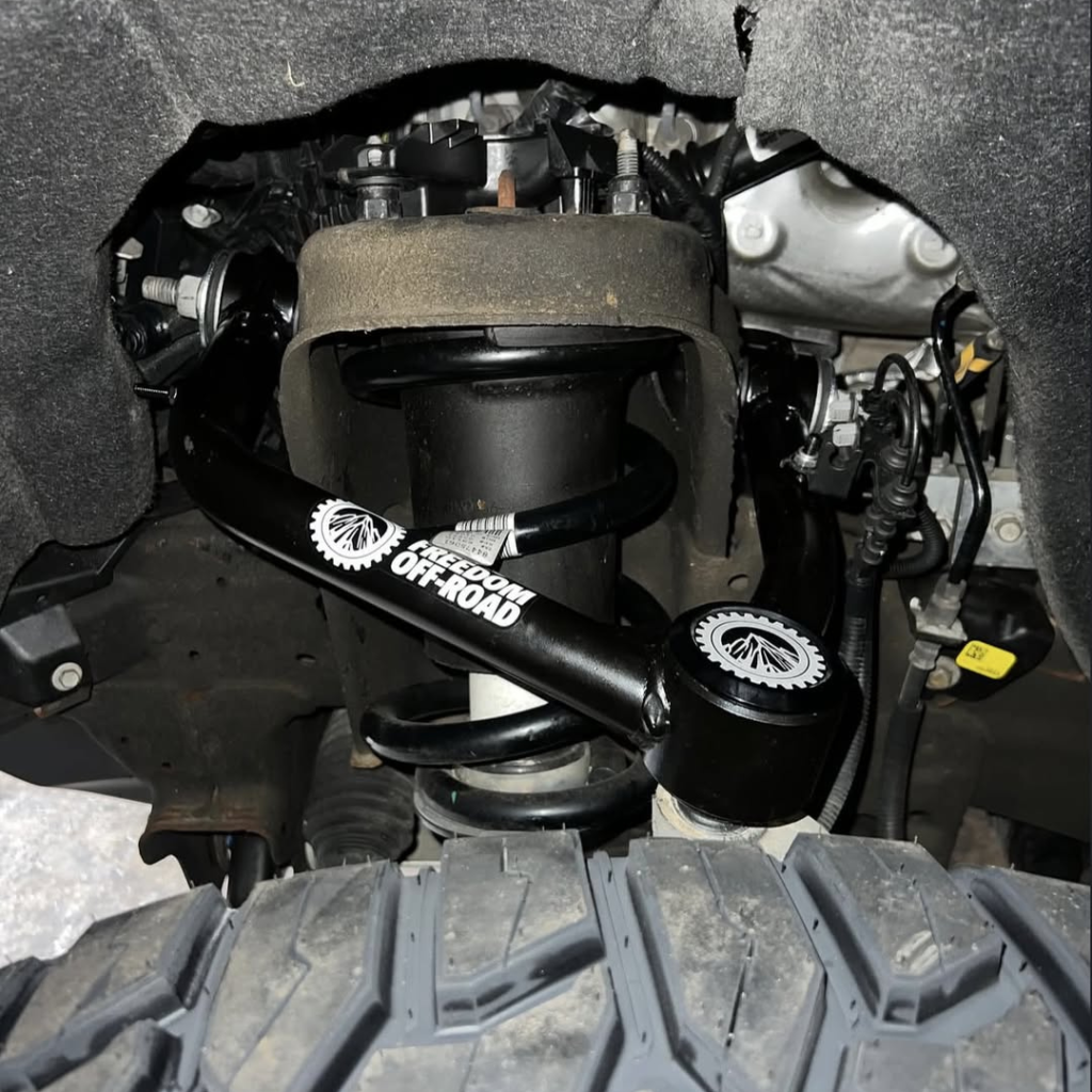 
Installed Freedom Off-Road upper control arm on a 4x4 suspension system.